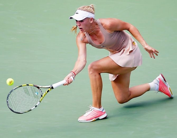 Caroline Wozniacki of Denmark returns a shot against Shuai Peng of China