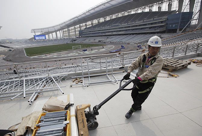  A labourer works at the Incheon Asiad Main Stadium in Incheon
