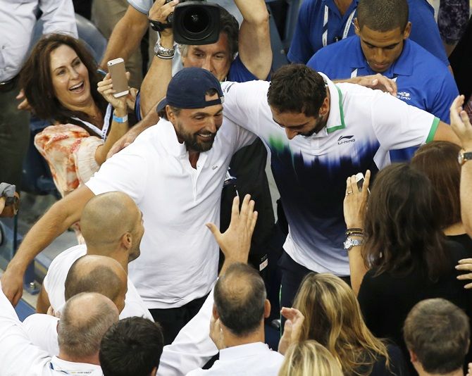 Marin Cilic of Croatia goes into the  stands to embrace his coach Goran Ivanisevic