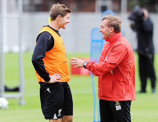 Brendan Rodgers manager of Liverpool talking with Steven Gerrard during a training session at at Melwood Training Ground 