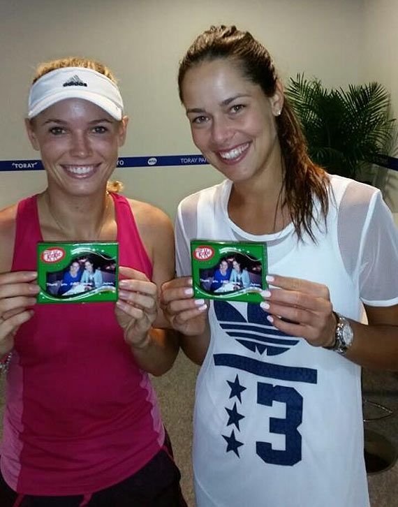 Caroline Wozniacki and Ana Ivanovic show off their pictures on the chocolate wrapper