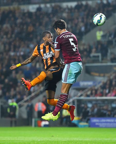 Hull striker Abel Hernandez beats West Ham defender James Tomkins (right) in an aerial challenge to score the first goal at KC Stadium in Hull on Monday