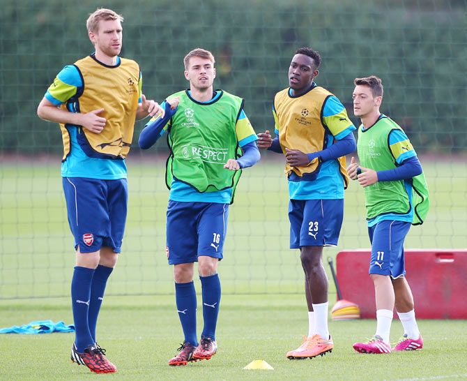 (Left-Right) Arsenal's Per Mertesacker, Aaron Ramsey, Danny Welbeck and Mesut Ozil warm up during a training session, on Monday, ahead of their Champions League match against Borussia Dortmund in St Albans, England