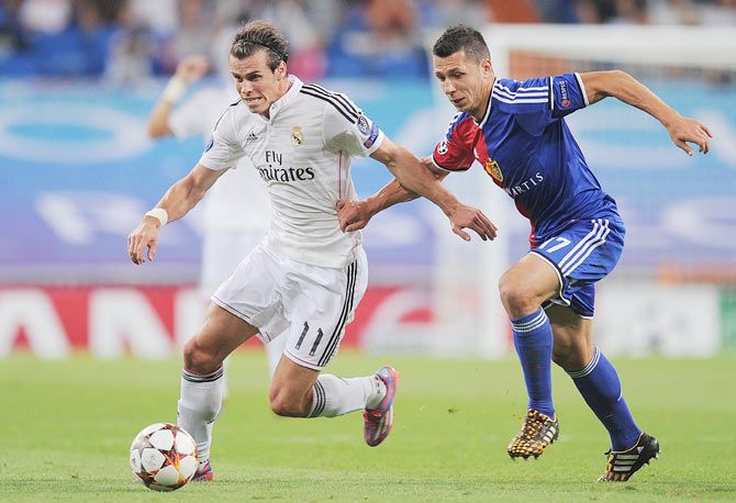 Gareth Bale of Real Madrid is challenged by Marek Suchy of FC Basel 1893 