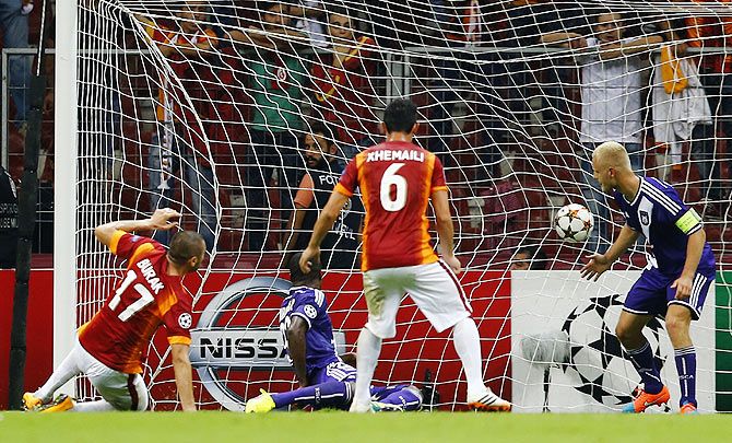 Burak Yilmaz of Galatasaray (L) scores against Anderlecht during their Champions League Group D soccer match in Istanbul on Tuesday