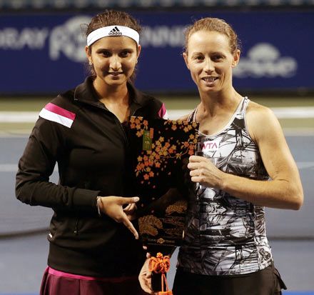 Sania Mirza (left) and Cara Black of Zimbabwe pose with the trophy.
