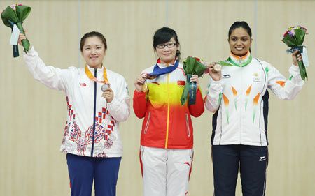 Gold Medalist Mengyuan Zhang of China (C), Silver Medalist Jung Jee-Hae of South Korea (L), and Bronze Medalist Shweta Chaudhry of India (R) celebrate on the podium