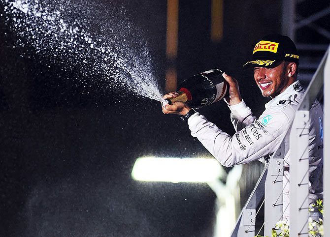 Lewis Hamilton of Great Britain and Mercedes GP celebrates on the podium after winning the Singapore Formula One Grand Prix at Marina Bay Street Circuit 