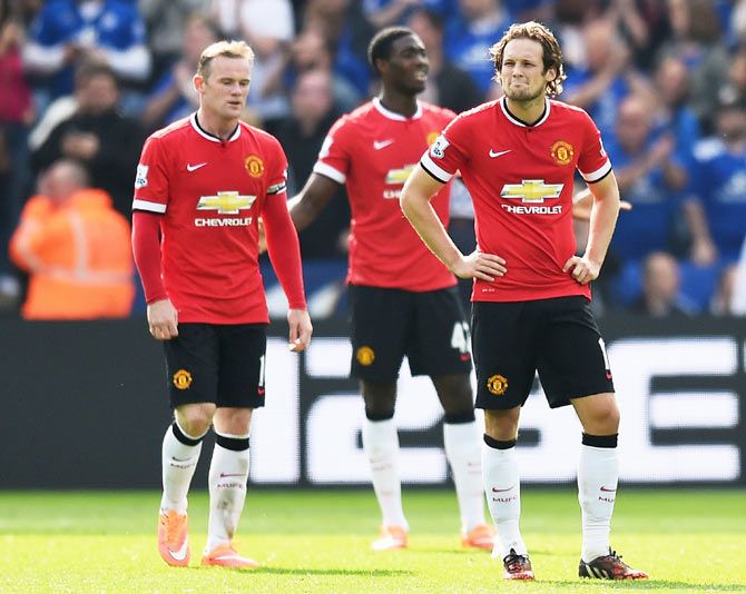 (Left-Right) Manchester United players Wayne Rooney, Tyler Blackett and Daley Blind wear a dejected look