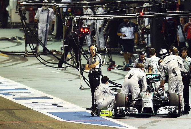 Nico Rosberg of Germany and Mercedes GP is pushed back to the garage during the formation lap after experiencing problems before the Singapore Formula One Grand Prix