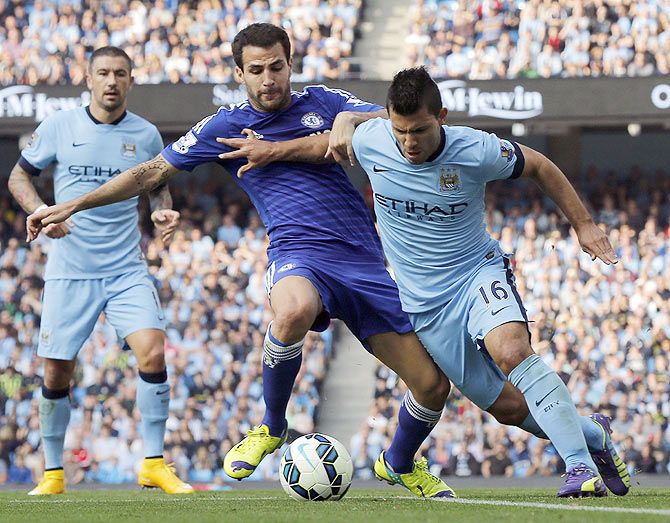 Chelsea's Cesc Fabregas (centre) challenges Manchester City's Sergio Aguero on Sunday