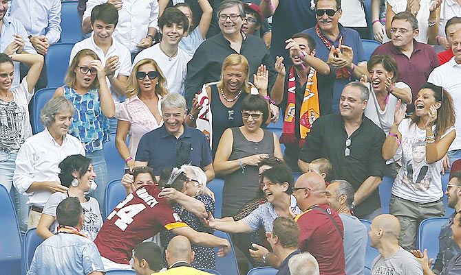 AS Roma's Alessandro Florenzi (bottom, left) hugs his grandmother as he celebrates his goalagainst Cagliari during their Italian Serie A match at the Olympic stadium in Rome on Sunday