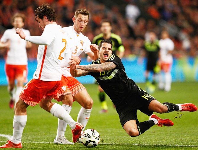 Vitolo of Spain goes to ground challenged by Daryl Janmaat
