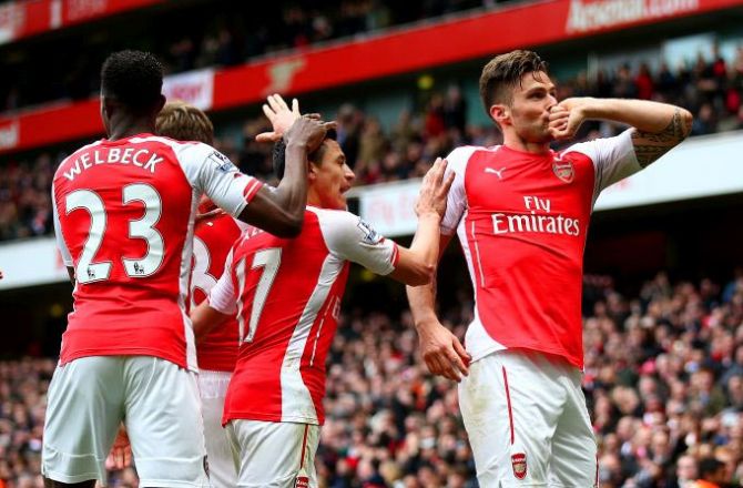 Olivier Giroud of Arsenal (right) celebrates with teammates after scoring against Liverpool during the Barclays Premier League match at Emirates Stadium on Saturday