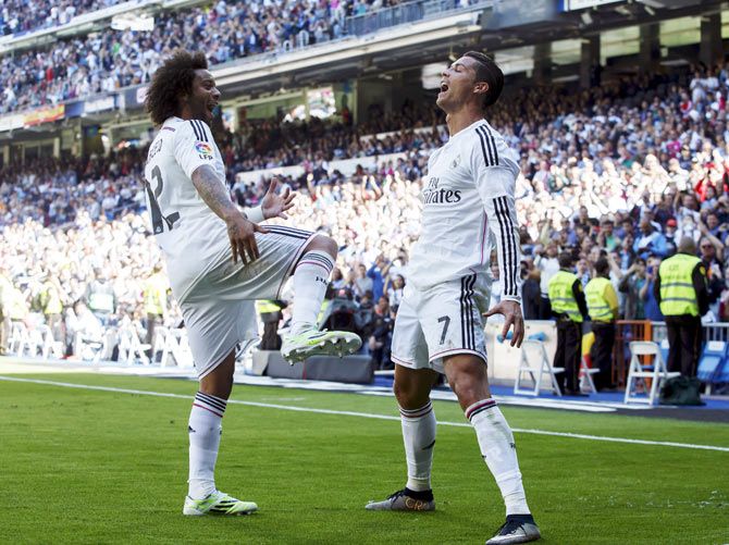 Real Madrid's Cristiano Ronaldo celebrates his fifth goal with teammate Marcelo (left) during their La Liga match against Granada at Santiago Bernabeu stadium in Madrid on Sunday
