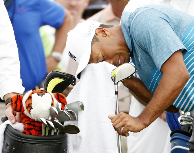 Tiger Woods wipes his face before hitting the first tee during a practice round ahead of the 2015 Masters at the Augusta National Golf Course. Photograph: Phil Noble/Reuters