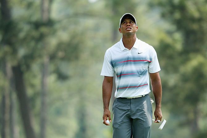 Tiger Woods of the United States walks across the third green during the first round of the 2015 Masters Tournament at Augusta National Golf Club
