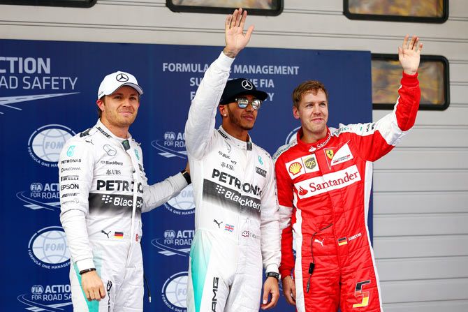Lewis Hamilton of Great Britain and Mercedes GP celebrates in Parc Ferme next to Nico Rosberg of Germany and Mercedes GP and Sebastian Vettel of Germany and Ferrari after claiming pole position in qualifying for the Formula One Grand Prix of China at Shanghai International Circuit on Saturday