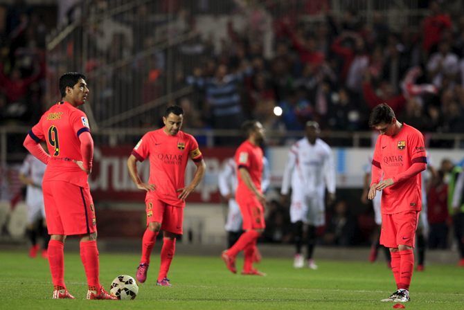 Barcelona players react after conceding a goal