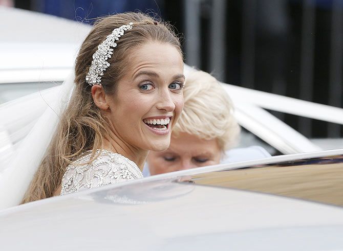 Kim Sears smiles as she leaves the cathedral