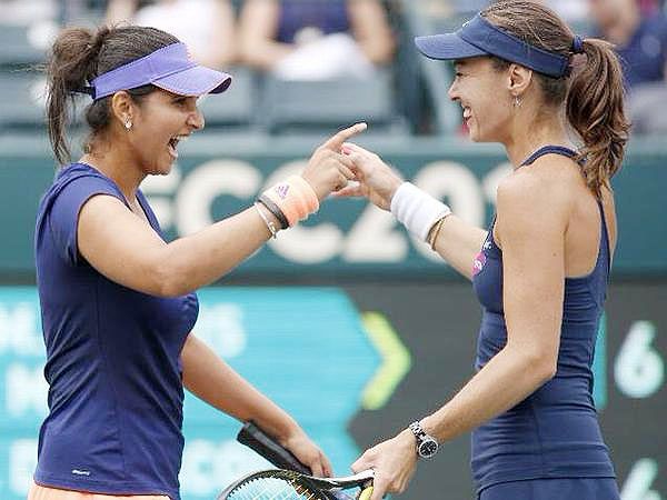 Sania Mirza and Martina Hingis celebrates on winning the Family Circle Cup in Charleston on Sunday