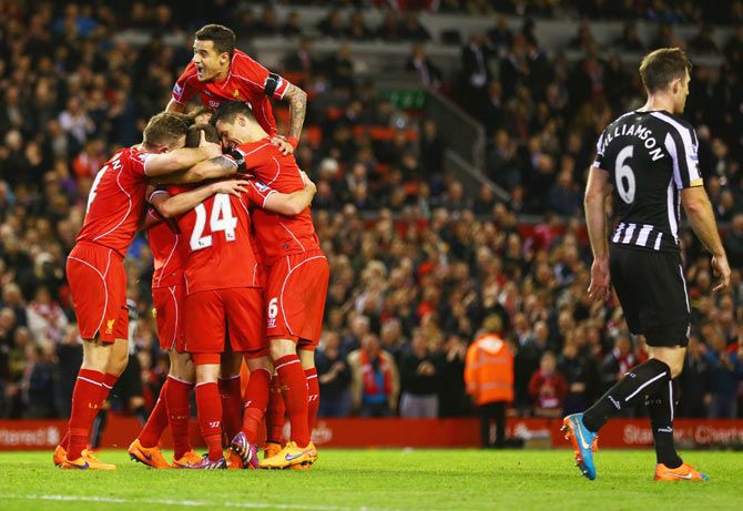 Liverpool players celerbate after Joe Allen scored the winner against Newcastle United during their English Premier League match at Anfield on Monday