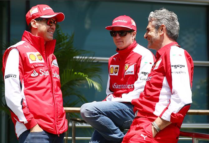 Ferrari Team Principal Maurizio Arrivabene chats with Kimi Raikkonen of Finland and Ferrari and Sebastian Vettel of Germany 