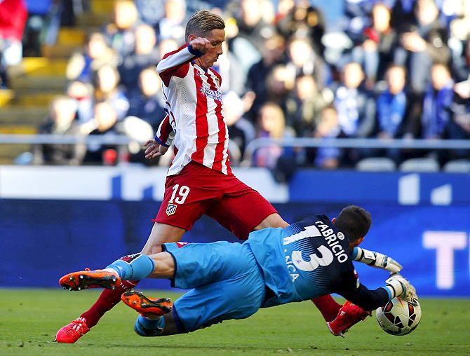 Deportivo Coruna's goalkeeper Fabricio (right) challenges Atletico Madrid's Fernando Torres during their match at Riazor stadium in Coruna on Saturday