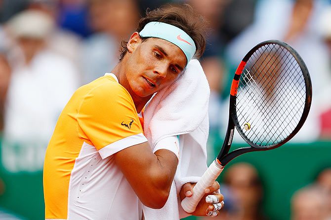 Spain's Rafael Nadal wipes his face during the Monte Carlo Masters semi-final against Serbia's Novak Djokovic on Saturday