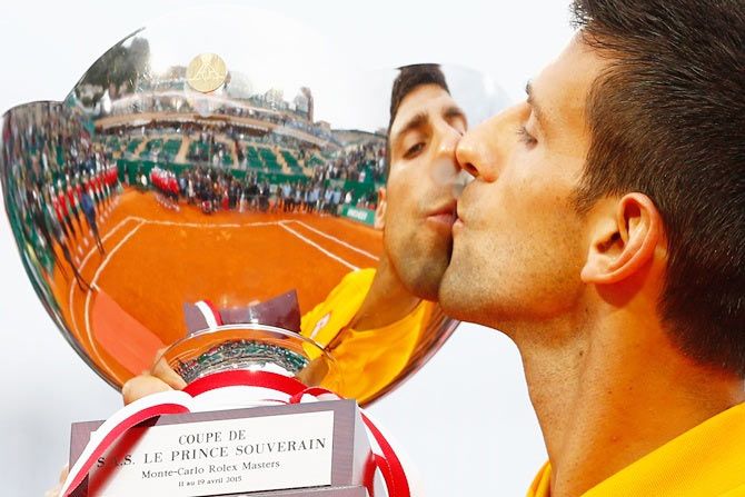 Novak Djokovic of Serbia celebrates with the winners trophy after claiming the Monte Carlo Masters on Sunday