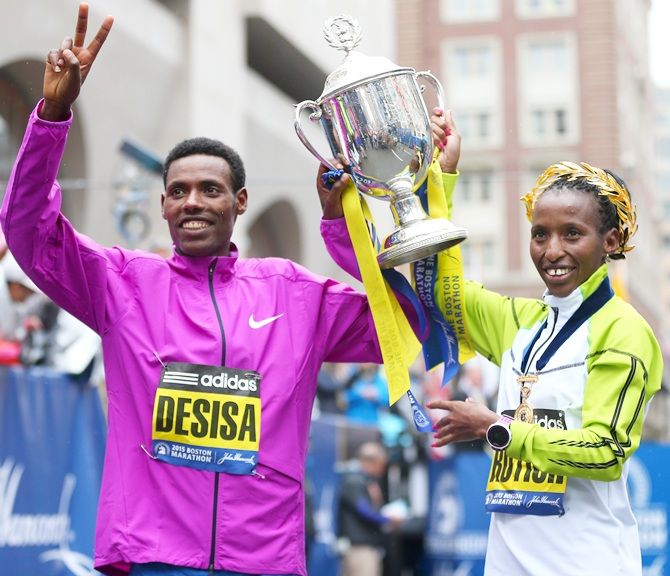Lelisa Desisa of Ethiopa, left, and Caroline Rotich of Kenya celebrate 