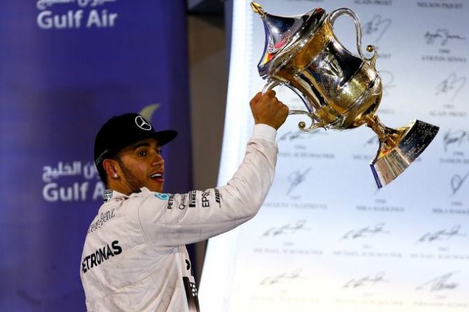 Mercedes GP and Great Britain's Lewis Hamilton celebrates with the trophy on the podium after winning the Bahrain Formula One Grand Prix