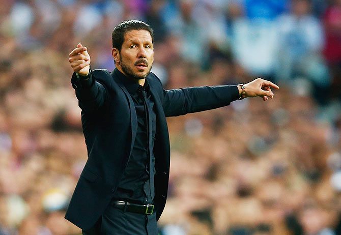 Diego Simeone head coach of Atletico Madrid signals his players during their UEFA Champions League match against Real Madrid on Wednesday