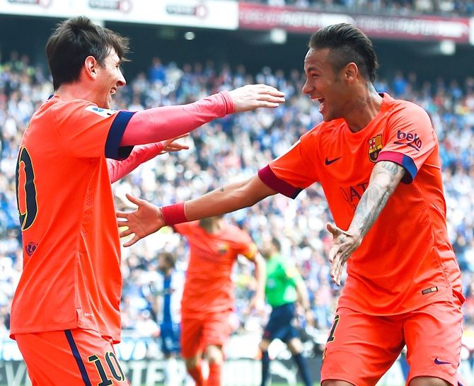Lionel Messi of FC Barcelona celebrates with his team mate Neymar