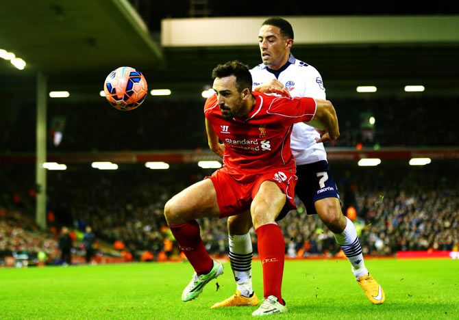 Liverpool's Jose Enrique shields the ball from Liam Feeney of Bolton Wanderers