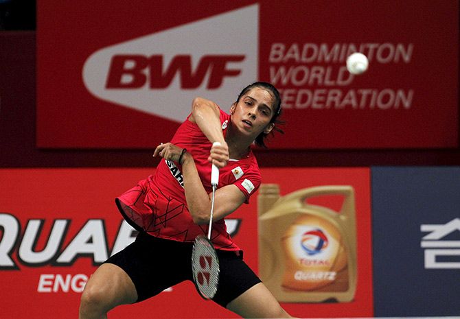 Saina Nehwal returns a shot to China's Wang Yihan during their women's singles quarter-final at the World Championships 