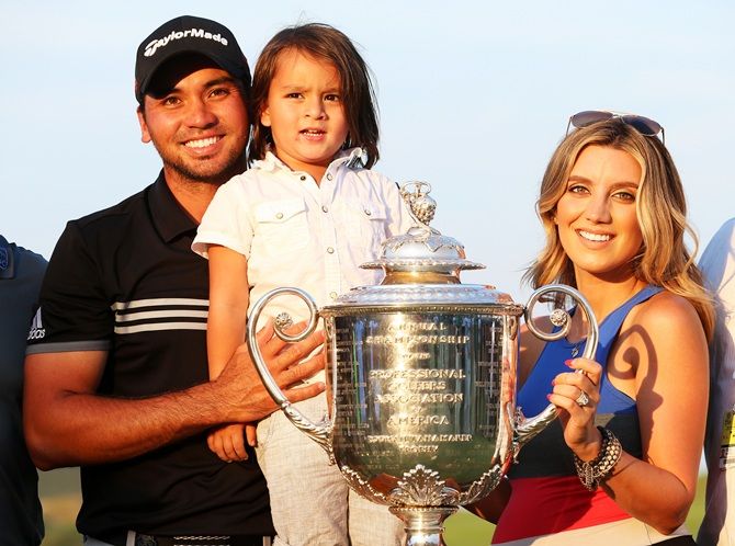 Jason Day of Australia poses with the Wanamaker trophy and his wife Ellie and son Dash