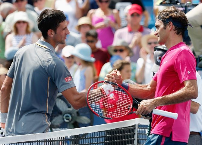 Roger Federer of Switzerland, right, shakes hands with Novak Djokovic