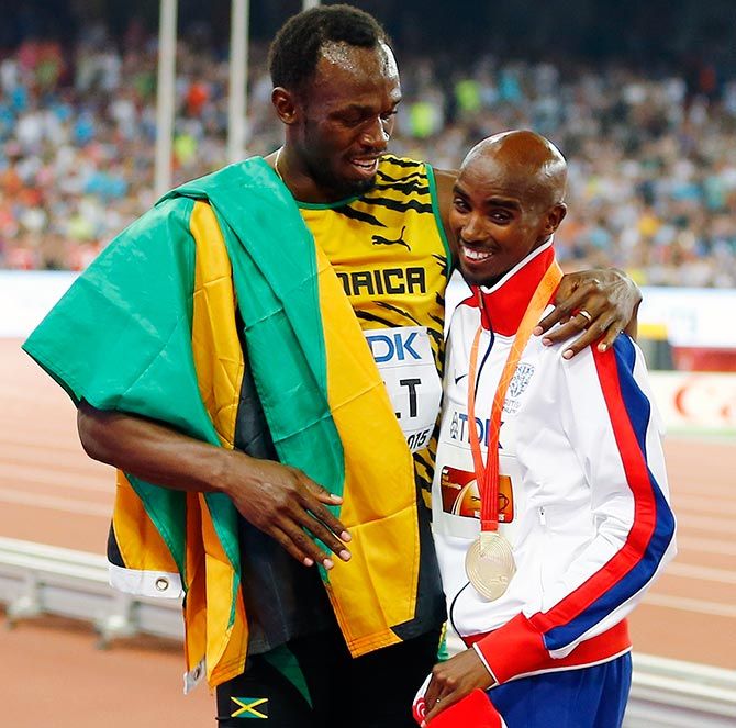 Usain Bolt of Jamaica (left) hugs Mo Farah of Britain, gold medal, after the podium ceremony for the men's 5,000 metres event during the during the 15th IAAF World Championships in Beijing