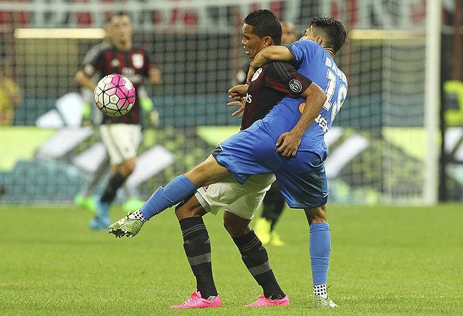AC Milan's Carlos Bacca (left) is challenged by Empoli FC's Federico Barba during their Serie A match at Stadio Giuseppe Meazza in Milan on Saturday