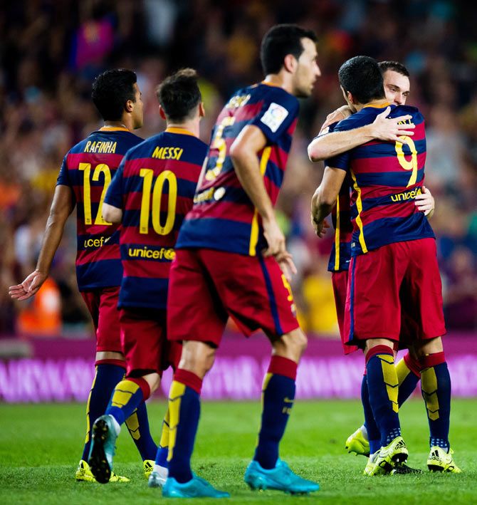 FC Barcelona's Thomas Vermaelen (2nd from right) is congratulated by his temmate Luis Suarez after scoring the opening goal