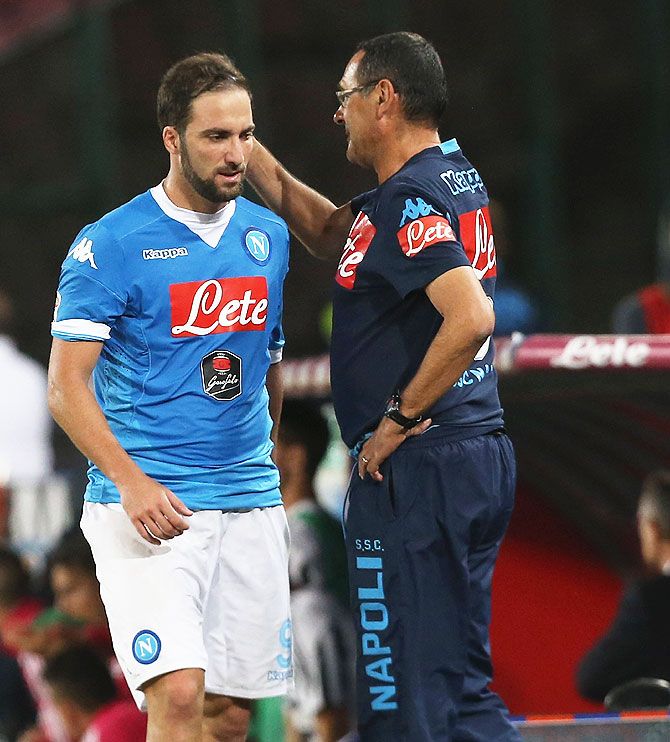 Napoli's Gonzalo Higuain (left) gets a pat from coach Maurizio Sarri