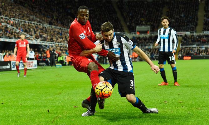 Newcastle's Paul Dummett (right) challenges Liverpool's Divock Origi