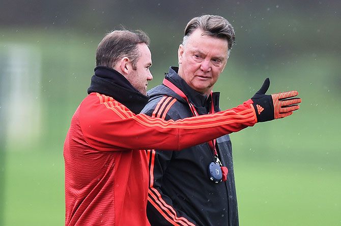 Manchester United's Wayne Rooney (left) and manager Louis van Gaal in discussion during a team training session at Aon Training Complex
