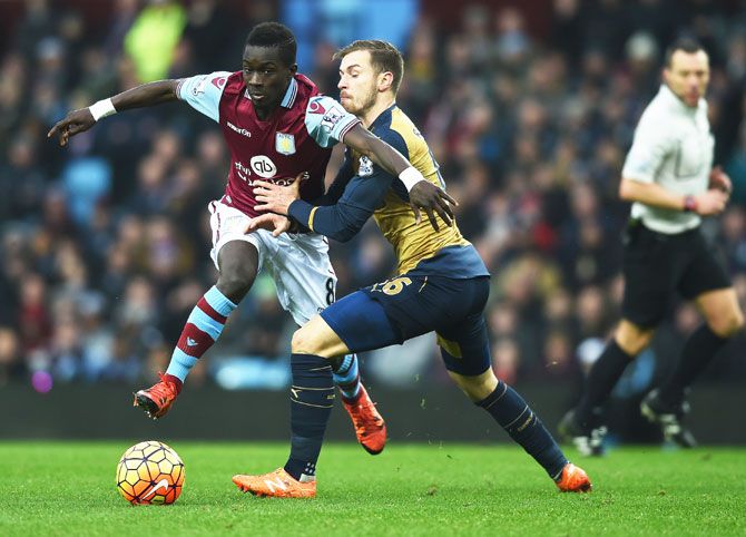 Aston Villa's Idrissa Gueye holds off Arsenal's Aaron Ramsey