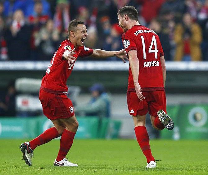 Bayern Munich's Rafinha and Xabi Alonso celebrate the first goal against SV Darmstadt 98