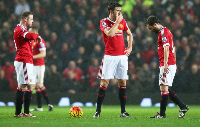 Manchester United's Wayne Rooney, Michael Carrick and Juan Mata react after Norwich City's second goal at Old Trafford