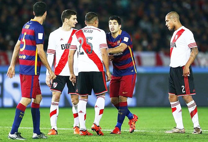 FC Barcelona's Luis Suarez clashes with River Plate's Gabriel Mercado