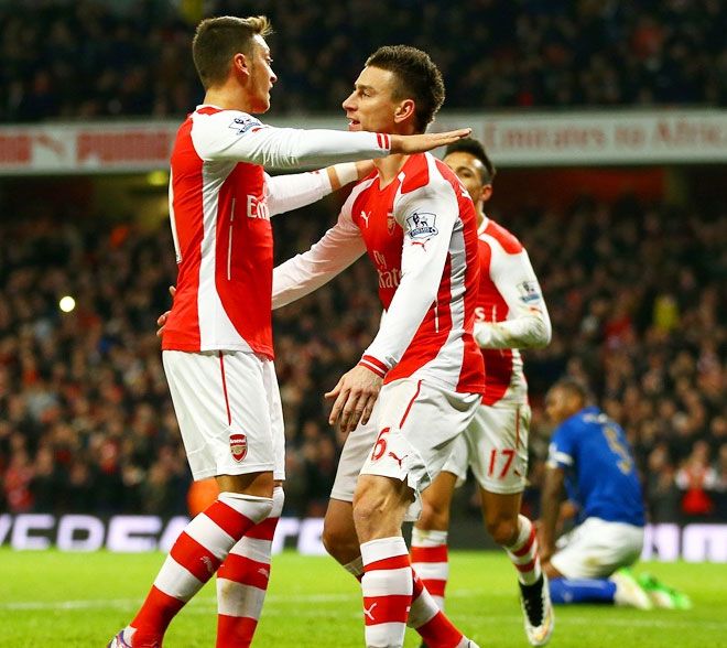 Arsenal defender Laurent Koscielny (right) celebrates with teammate Mesut Ozil