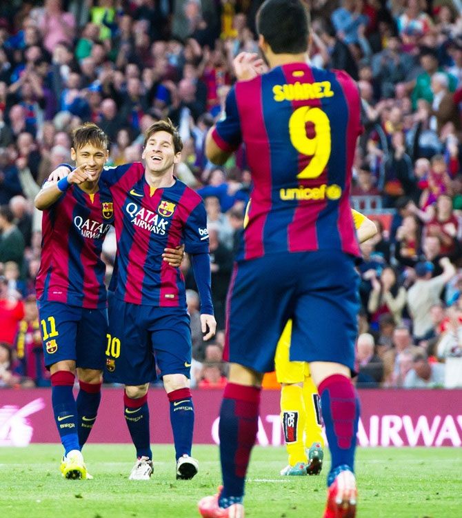 FC Barcelona's Neymar celebrates with his teammate Lionel Messi, right, while Luis Suarez applauds
